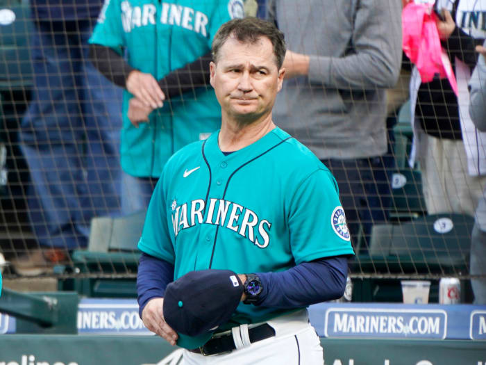 Seattle Mariners manager Scott Servais holds his cap as he stands near the dugout before a baseball game against the Houston Astros, Friday, May 27, 2022, in Seattle.